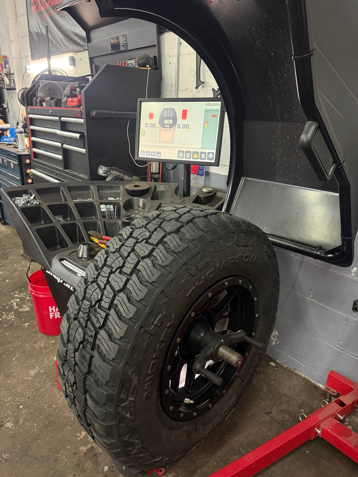 Oversized off-road tire being Road Force balanced at Falcon Garage in Columbus Ohio