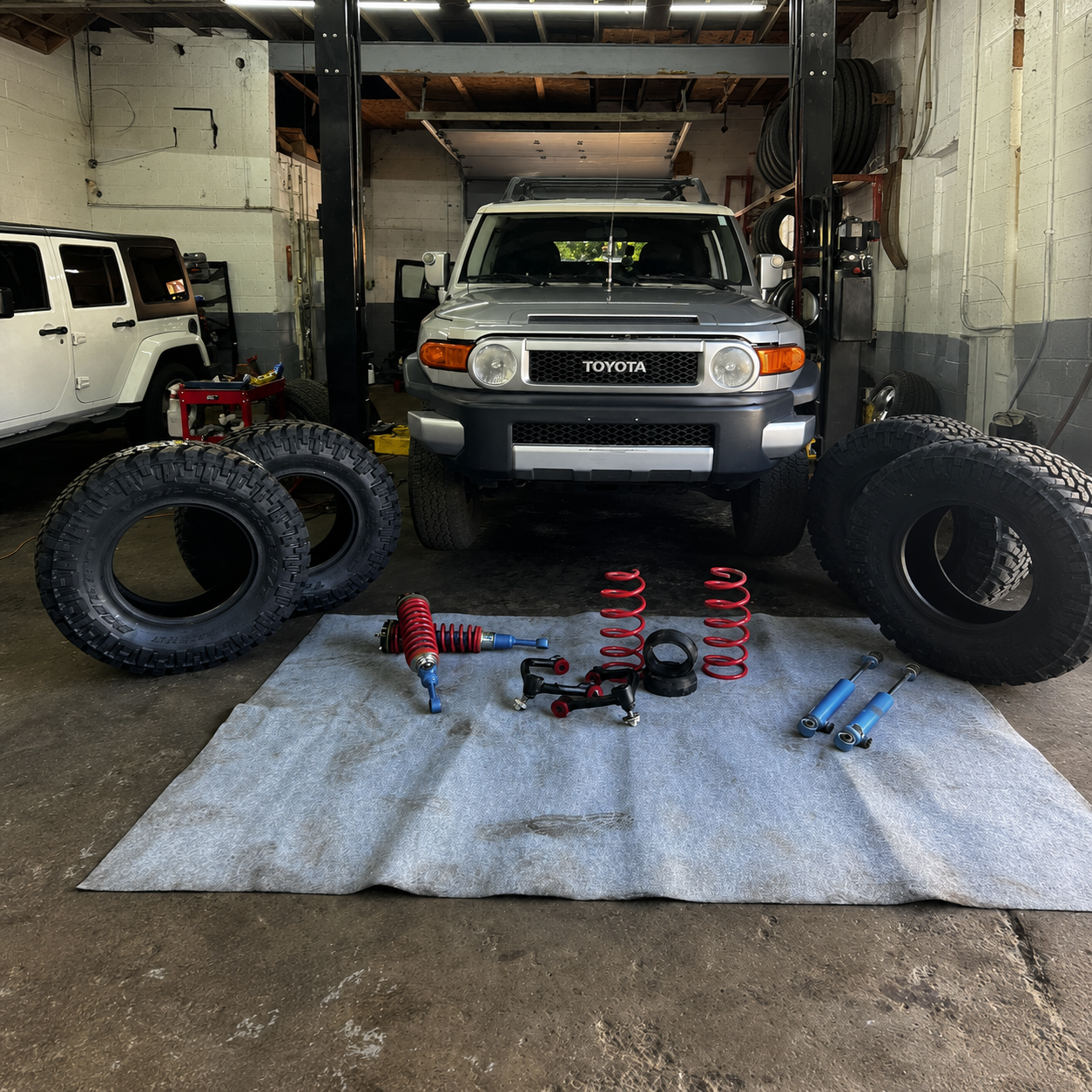 Toyota FJ Cruiser with suspension kit components prepared for installation at Falcon Garage